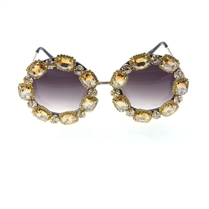Detail of amber crystal rhinestones on oversized metal frame fashion sunglasses