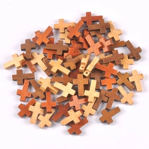 Macro detail of mixed color wooden cross beads with pre-drilled holes for DIY jewelry