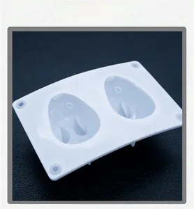 Detail of white silicone jelly mold featuring two oval cavities with cute animal faces
