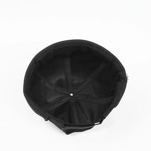 Internal view of black cotton Miki Hat showing reinforced stitching and metal center button