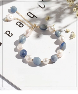Detail of adjustable bracelet with white baroque pearls and blue aventurine stones