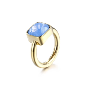 Gold titanium steel ring with a square-cut blue zircon stone on a white background