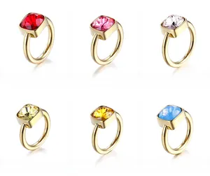 Detail showing six colors of square-cut zircon stones set in gold titanium steel rings