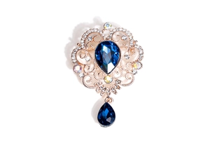 Detailed view of baroque brooch with pear-shaped blue crystals and gold-tone metal base