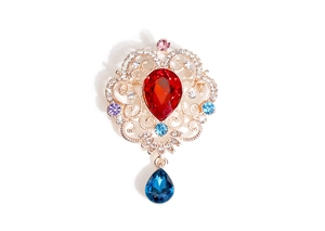 Close-up of Baroque brooch with colorful crystal droplets and gold metal plating