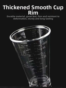 Macro shot of clear PC resin jigger showing dual scales for ounces and milliliters