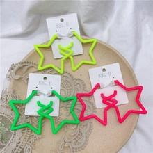 Neon color oversized hollow star earrings in yellow, green and pink on card