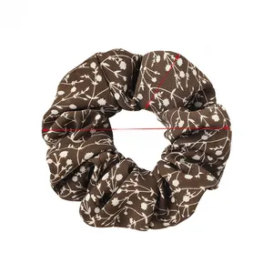 Detail of dark brown floral scrunchie showing fabric texture and 4.7-inch outer diameter