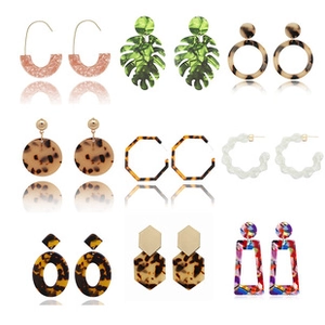 Collection of nine geometric acrylic earrings featuring leopard print and leaf designs