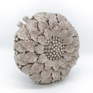 Close-up of silver sunflower evening bag featuring dense crystal rhinestones and metal clasp