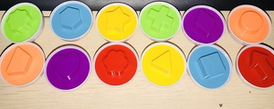 Top view of 12 colorful geometric shape matching inserts for educational egg toys