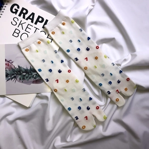 Japanese style white Tabi socks with colorful digital patterns in a minimalist layout