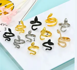 Macro view of cobra rings with snake scale texture in gold silver and black matte finish