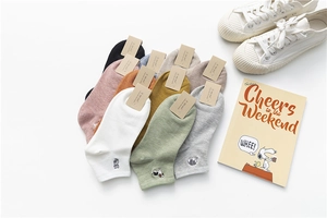 Flat lay of colorful cotton socks with cute animal embroidery and branded tags