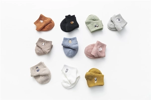 Flat lay of colorful cotton socks set featuring various cute embroidered animal patterns