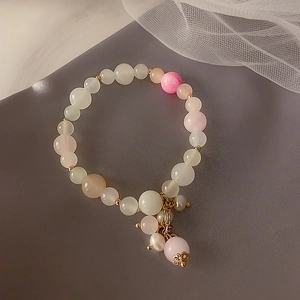 Pink and white strawberry crystal beaded bracelet with gold accents and pearl charm