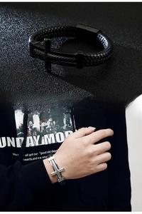 Detail of woven leather bracelet featuring stainless steel cross buckle in punk style
