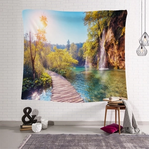 Detail of landscape tapestry featuring waterfall and forest on a white brick wall