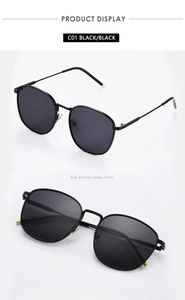 Detail view of square metal frame sunglasses with black lenses and gold ball tips