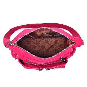 Waterproof rose red nylon multi-pocket shoulder bag with spacious interior compartments