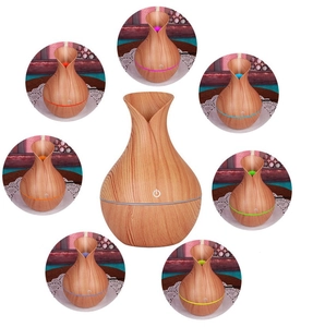 Detail view of the colorful LED light cycle on the wood grain aromatherapy diffuser