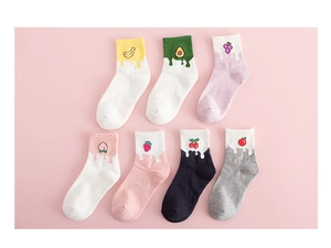 Flat lay of seven pairs of cotton mid-tube socks with cute fruit embroidery motifs