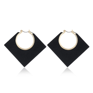 Modern geometric earrings featuring black rhombus wood with golden circular metal loops