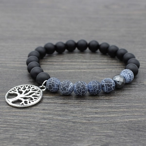 Tiger Eye and lava stone mala bracelet with silver Tree of Life charm on wood surface