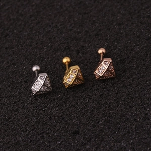 Close-up of diamond-shaped zircon screw back earrings in silver, gold, and rose gold