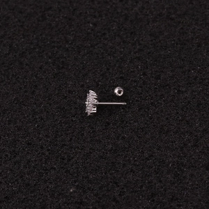 Macro view of flower-shaped stud earring with cubic zirconia and threaded screw back