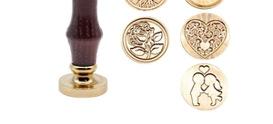 Detailed view of wooden handle wax seal stamps with interchangeable brass heads and patterns