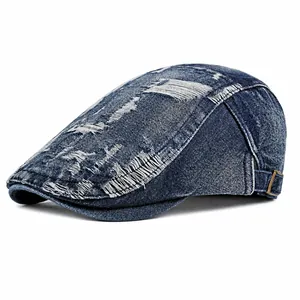 Distressed blue denim beret with vintage-style frayed holes and adjustable metal side buckle