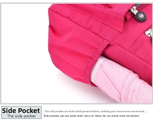 Detail of side elastic pocket on pink nylon crossbody bag holding a folded umbrella