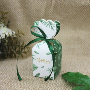 Detail of European gift box with green leaf pattern and dark green ribbon bow tie