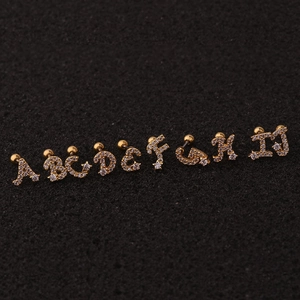 Golden alphabet stud earrings set from A to I with cubic zirconia inlay on black background