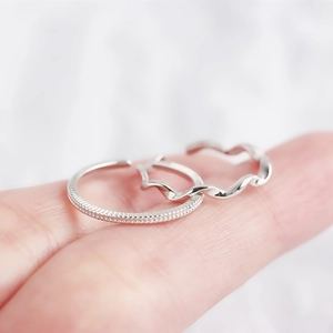 Detail of S925 sterling silver Mobius rings with beaded texture and twisted design