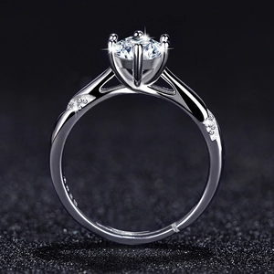 Detail of six-prong setting on S925 silver ring with criss-cross band and side diamonds