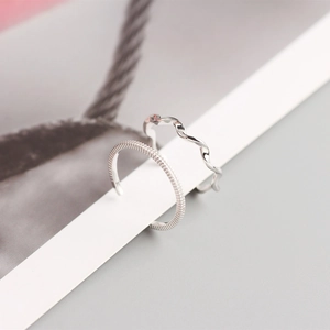 Detail of S925 silver Mobius rings featuring twisted wave design and vertical texture