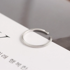 Macro detail of S925 sterling silver Mobius ring featuring textured beaded edges
