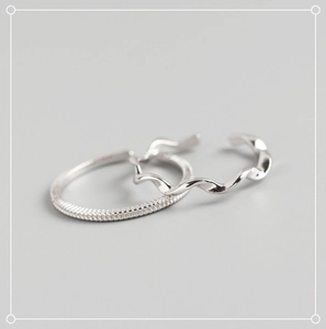 Detailed view of S925 sterling silver Mobius rings with textured and wavy twist designs