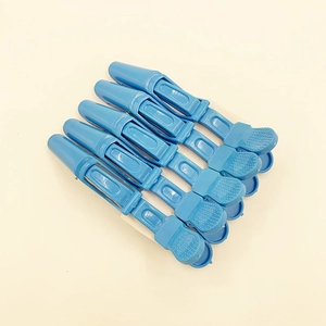 Close-up of blue professional hair clips with double-hinge design for sectioning