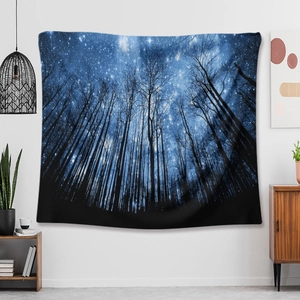 Detail of wall tapestry featuring starry night forest design in blue tones for home decor
