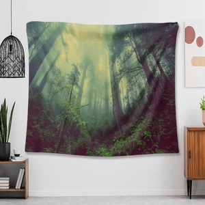 Detailed view of a forest morning mist tapestry hung on a white wall in a home setting