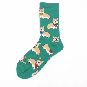 Detail of green cotton crew socks with colorful corgi patterns wearing bright scarves