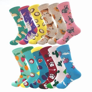 Flat lay of twelve pairs of cotton mid-calf socks with colorful cartoon animal and fruit patterns