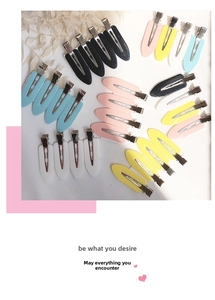 Flat lay of colorful seamless duckbill hair clips with matte finish on white surface
