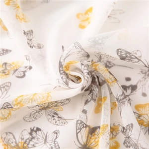 Detailed texture of cotton linen scarf with yellow and gray butterfly and dragonfly patterns