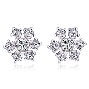 Macro shot of silver snowflake earrings with cubic zirconia pavé on white background