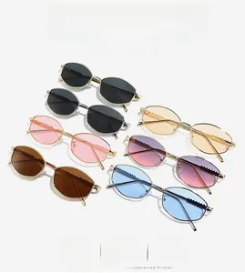Detailed collection of seven colored oval metal frame sunglasses with wave patterned temples