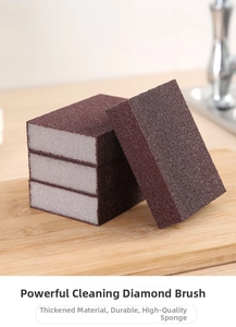 Close-up of four emery cleaning sponges on a wooden board in a modern kitchen setting